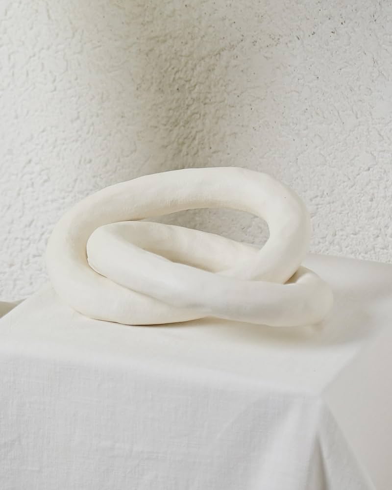 Minimalist White Sculptural Ceramic Knot Decor on Linen